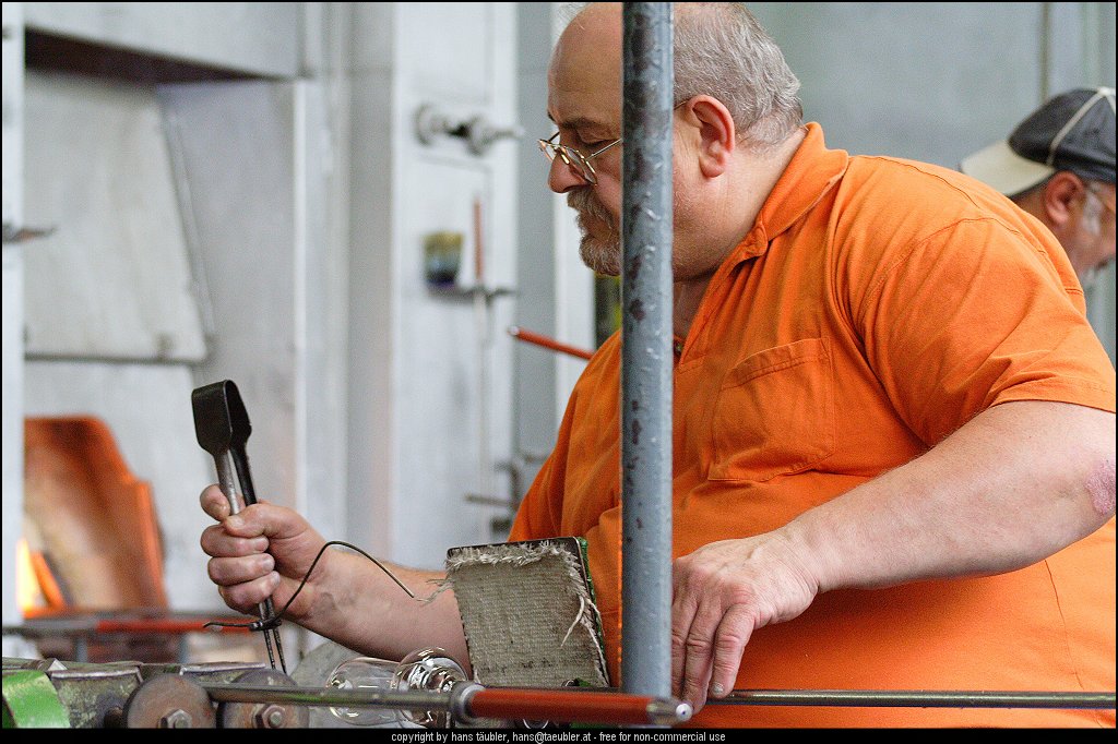 20060809_IMG_glas_30.JPG - Geschick und genaues Arbeiten ist notwendig, um den Glasstiel aus dem noch gl�hend heissen Glas ziehen zu k�nnen - Spiegelau, Bayern
